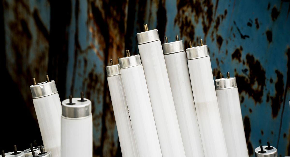 fluroescent tube lights stacked against a wall